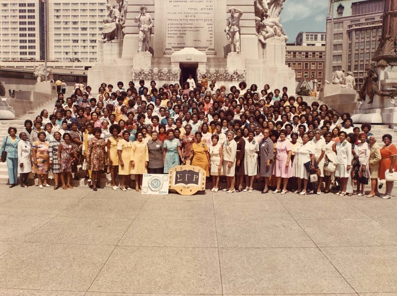 Sigma Gamma Rho sorority sisters stand outside in front of statues in 1972